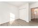 Well-lit bedroom with vinyl flooring and access to bathroom at 1609 Pickerel Ct, Kissimmee, FL 34759