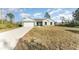 Newly built home with a two car garage and a large front yard at 1609 Pickerel Ct, Kissimmee, FL 34759