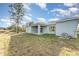 House exterior view, showcasing back patio and yard at 1609 Pickerel Ct, Kissimmee, FL 34759