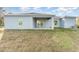 House exterior showcasing a back patio and grassy yard at 1609 Pickerel Ct, Kissimmee, FL 34759