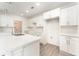Modern white kitchen with an island and stainless steel appliances at 1609 Pickerel Ct, Kissimmee, FL 34759