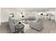 Open concept living area with modern furniture and a kitchen at 1609 Pickerel Ct, Kissimmee, FL 34759