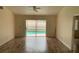 Living room with laminate flooring and sliding doors leading to the pool at 236 Bay Head Dr, Kissimmee, FL 34743