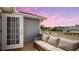 Relaxing balcony with wicker furniture and sunset view at 2377 Victoria Dr, Davenport, FL 33837