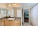 Bathroom with single sink vanity, granite countertop, and a view of a bunk bed room at 2377 Victoria Dr, Davenport, FL 33837