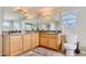 Large bathroom with dual sinks, granite countertops, and a toilet at 2377 Victoria Dr, Davenport, FL 33837