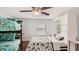 Bedroom with full-size bed, bunk bed, and ceiling fan at 2377 Victoria Dr, Davenport, FL 33837