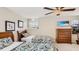 Bedroom with two twin beds, dresser, and mounted TV at 2377 Victoria Dr, Davenport, FL 33837