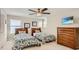 Bedroom with two twin beds, dresser, and mounted TV at 2377 Victoria Dr, Davenport, FL 33837