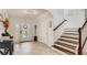 Bright and spacious entryway with tile floors and a staircase at 2377 Victoria Dr, Davenport, FL 33837