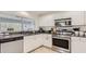 Bright kitchen featuring granite countertops and white cabinetry at 2377 Victoria Dr, Davenport, FL 33837