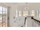 Upstairs hallway with access to balcony and decorative chandelier at 2377 Victoria Dr, Davenport, FL 33837