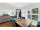 Dining area with natural light, wood table, and view of the living room at 3568 Westerham Dr, Clermont, FL 34711