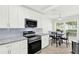 Modern kitchen featuring white cabinets, stainless steel appliances, and granite countertops at 3568 Westerham Dr, Clermont, FL 34711