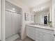 Bathroom with double vanity, granite countertop, and shower/tub combo at 4250 Lana Ave, Davenport, FL 33897