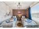 Bedroom with two twin beds, Hogwarts theme, and brick feature wall at 4250 Lana Ave, Davenport, FL 33897