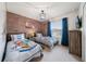 Bedroom with two twin beds, Hogwarts theme, and brick feature wall at 4250 Lana Ave, Davenport, FL 33897