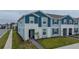 Blue townhome with walkway and landscaping at 4250 Lana Ave, Davenport, FL 33897