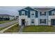 Two-story townhome with blue exterior and walkway at 4250 Lana Ave, Davenport, FL 33897
