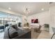 Living room features a comfortable couch and access to backyard patio and pool at 4250 Lana Ave, Davenport, FL 33897