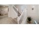 Elegant staircase with white railings leading to the upper level at 4250 Lana Ave, Davenport, FL 33897