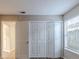Bedroom with double door closet and window at 5436 Wood Crossing St, Orlando, FL 32811