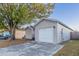 House exterior with a white garage door and landscaping at 5436 Wood Crossing St, Orlando, FL 32811