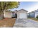 Tan house with white garage door and landscaping at 5436 Wood Crossing St, Orlando, FL 32811