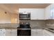 Updated kitchen featuring white cabinets and stainless steel appliances at 5436 Wood Crossing St, Orlando, FL 32811