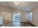 Living room with sliding doors to patio and vinyl flooring at 5436 Wood Crossing St, Orlando, FL 32811