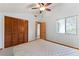 Bedroom with wood-paneled closet doors and carpeted floor at 5509 Bay Lagoon Cir, Orlando, FL 32819