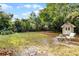 Spacious backyard with storage shed, sitting area, and lush greenery at 5628 Baybrook Ave, Orlando, FL 32819