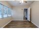 Bedroom with wood-look floors and view into hallway at 5815 Harrington Dr, Orlando, FL 32808