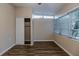 Bedroom with wood-look floors, window, and closet at 5815 Harrington Dr, Orlando, FL 32808