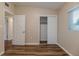 Bedroom with wood-look floors and a double door closet at 5815 Harrington Dr, Orlando, FL 32808