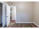 Bedroom with wood-look floors and door to another room at 5815 Harrington Dr, Orlando, FL 32808