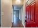 Bright entryway with red door and wood floors at 5815 Harrington Dr, Orlando, FL 32808