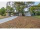 Tan house with long driveway and mature trees at 5815 Harrington Dr, Orlando, FL 32808
