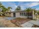 Tan house with sliding glass doors, multiple windows, and a large backyard at 5815 Harrington Dr, Orlando, FL 32808
