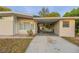 Tan house with carport, window, and landscaping at 5815 Harrington Dr, Orlando, FL 32808