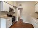 White kitchen cabinets and granite countertops at 5815 Harrington Dr, Orlando, FL 32808