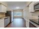 Kitchen with white cabinets, stainless steel appliances, and wood floors at 5815 Harrington Dr, Orlando, FL 32808