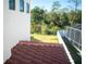 Partial view of backyard with tile roof and fenced area at 7493 Estuary Lake Loop, Kissimmee, FL 34747
