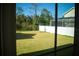 View of grassy backyard from inside the house at 7493 Estuary Lake Loop, Kissimmee, FL 34747