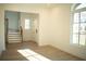 Bright entryway with wood-look floors, staircase, and large window at 7493 Estuary Lake Loop, Kissimmee, FL 34747