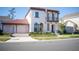 Two-story house with red tile roof, two-car garage, and landscaping at 7493 Estuary Lake Loop, Kissimmee, FL 34747