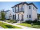 Two-story house with red tile roof, two-car garage, and landscaping at 7493 Estuary Lake Loop, Kissimmee, FL 34747