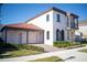 Two-story house with red tile roof and two-car garage at 7493 Estuary Lake Loop, Kissimmee, FL 34747