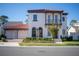 Two-story house with red tile roof, two-car garage, and landscaping at 7493 Estuary Lake Loop, Kissimmee, FL 34747