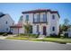 Two-story house with red tile roof, two-car garage, and landscaping at 7493 Estuary Lake Loop, Kissimmee, FL 34747